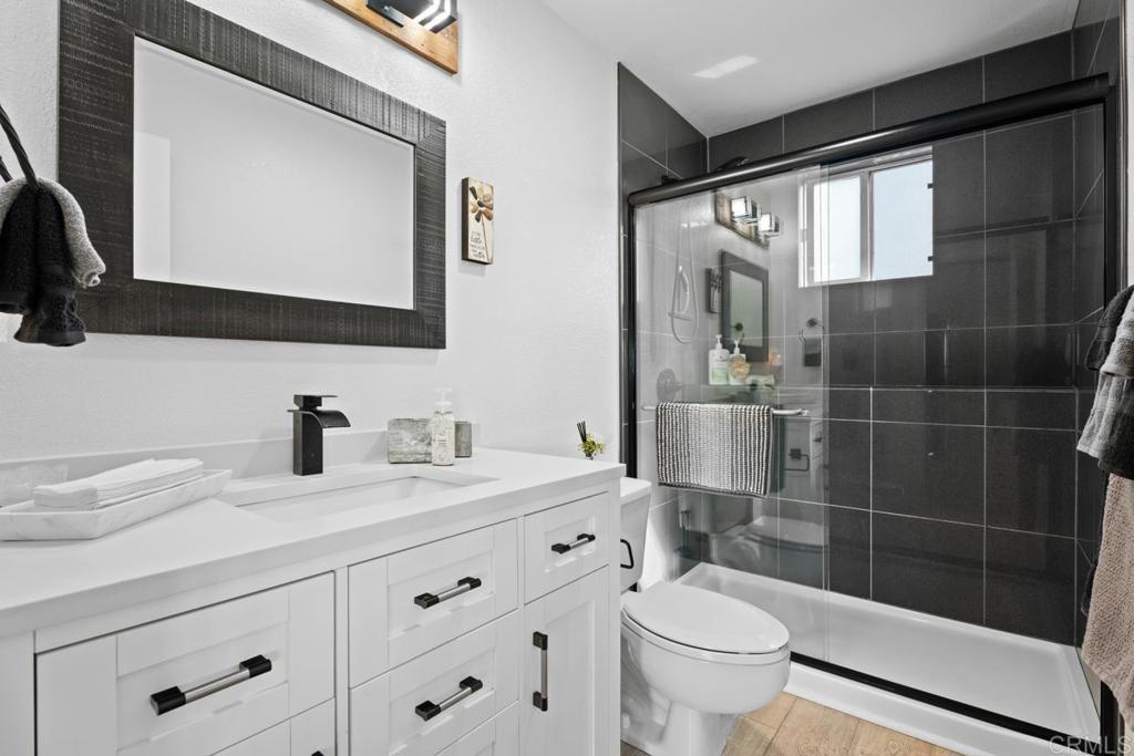 812 Sharon Way El Cajon, CA 92020 - Photo 62 of 65 a bathroom with a sink a toilet a mirror and shower