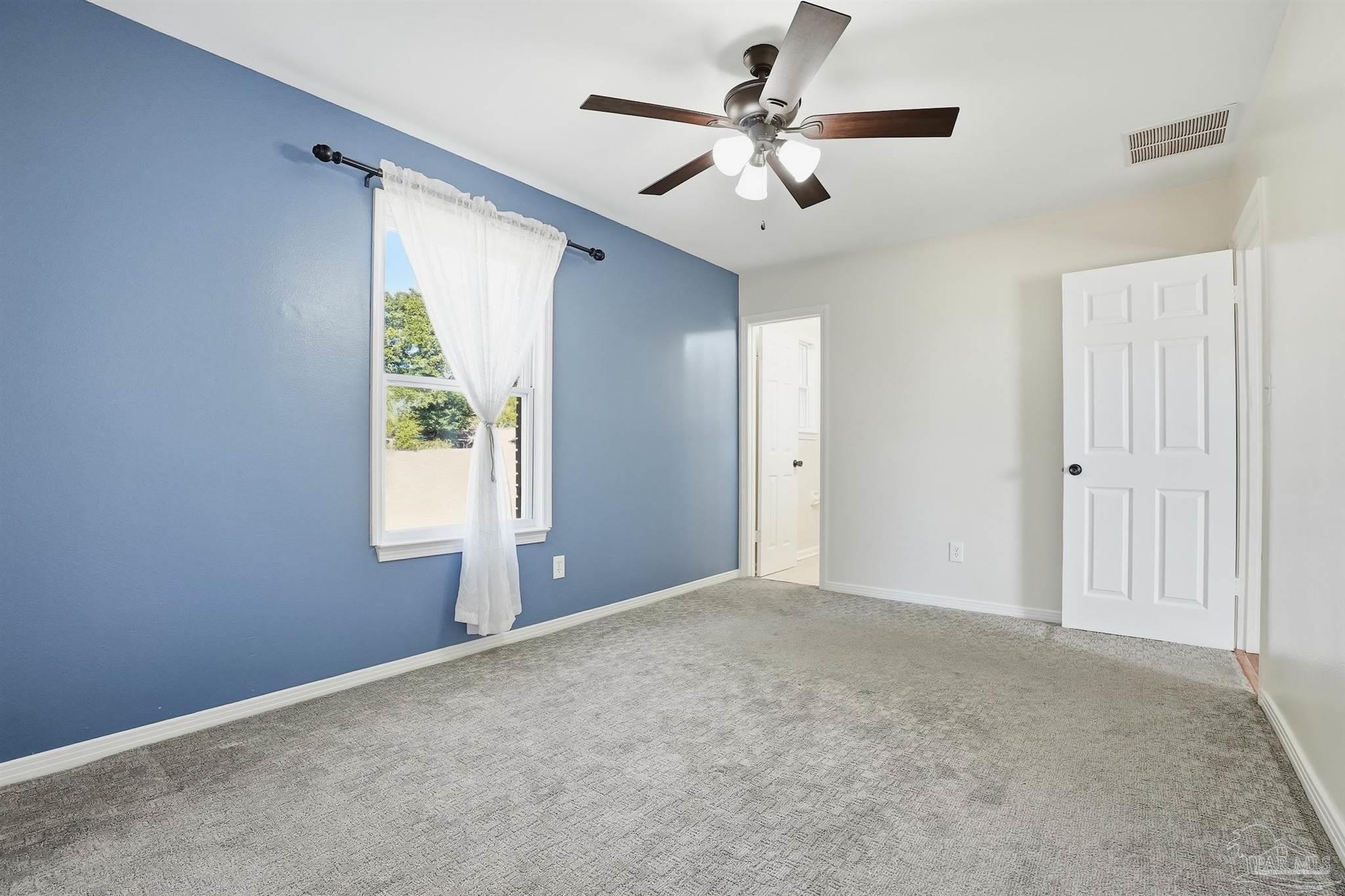 5590 Cyanamid Road Milton, FL 32583 - Photo 22 of 44 an empty room with windows and fan