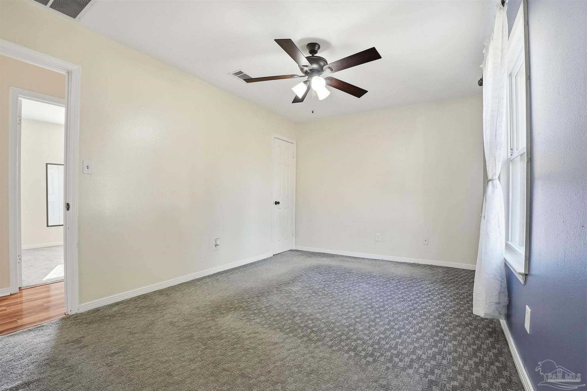5590 Cyanamid Road Milton, FL 32583 - Photo 24 of 44 an empty room with windows and fan