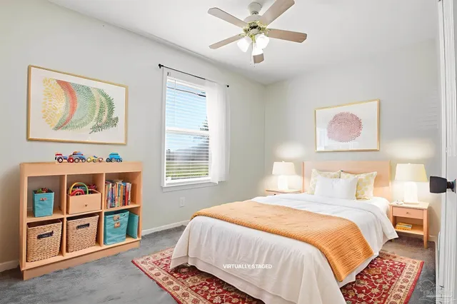 a bedroom with a bed painting on the wall and a window