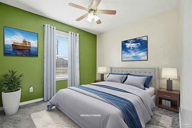 a bedroom with a large bed and a potted plant