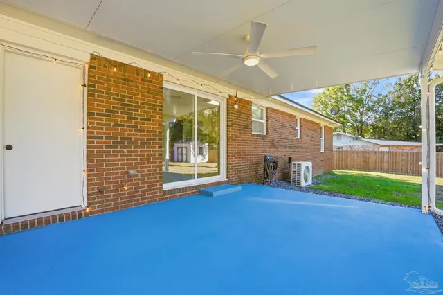 a view of backyard with deck and garden