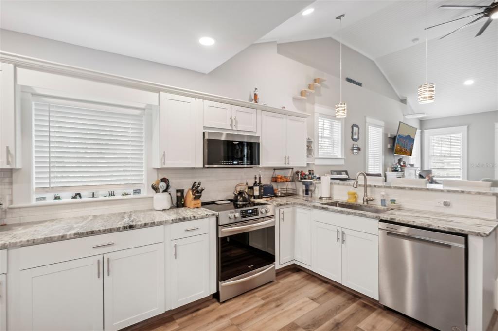 721 Myrtle Avenue Venice, FL 34285 - Photo 14 of 42 a kitchen with a sink stove cabinets and wooden floor