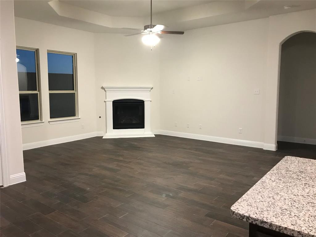 4111 Beamer Drive Forney, TX 75126 - Photo 16 of 25 a view of an empty room with a fireplace and a window