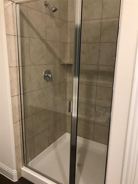 4111 Beamer Drive Forney, TX 75126 - Photo 21 of 25 a bathroom with a glass shower door
