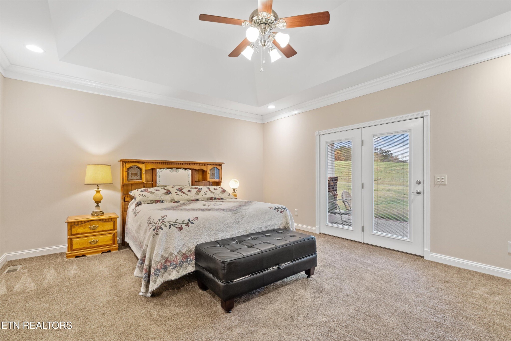 7613 Powderhorn Trail Townsend, TN 37882 - Photo 22 of 43 a bedroom with a bed and a chandelier