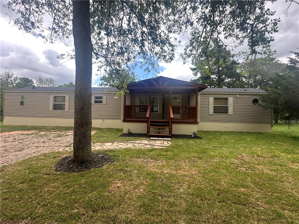 9855 Deer Ridge Lane Bryan, TX 77808 - Photo 2 of 8 a backyard of a house with yard table and chairs