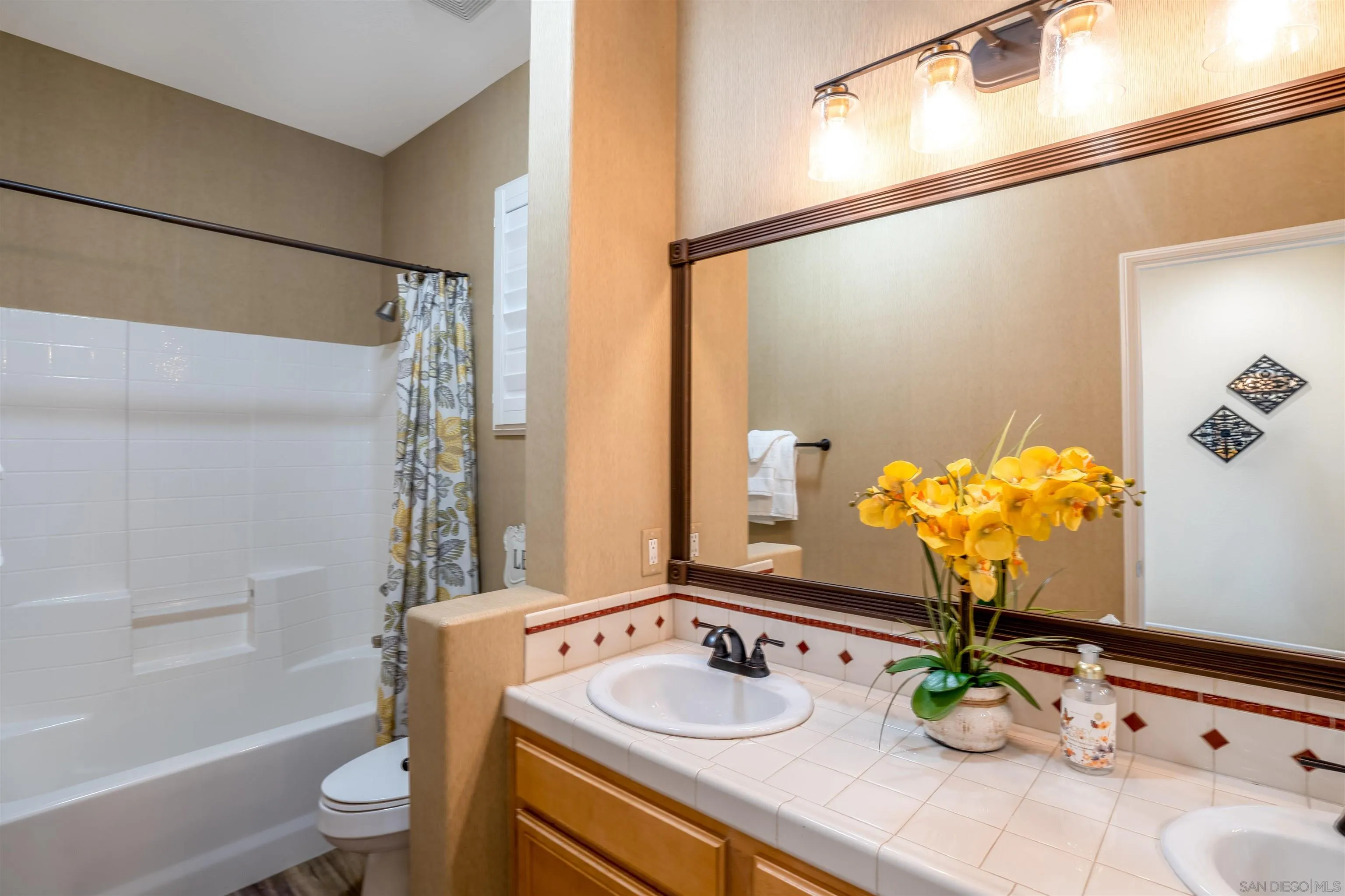38837 Rockinghorse Road Murrieta, CA 92563 - Photo 19 of 41 a bathroom with a granite countertop sink a toilet and a mirror