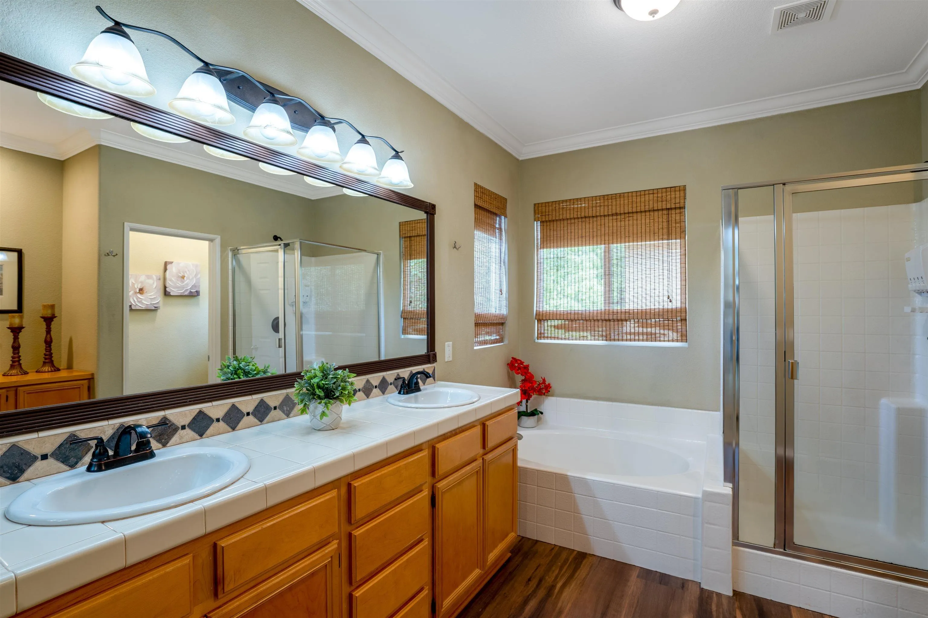38837 Rockinghorse Road Murrieta, CA 92563 - Photo 25 of 41 a bathroom with a tub double sink window and mirror