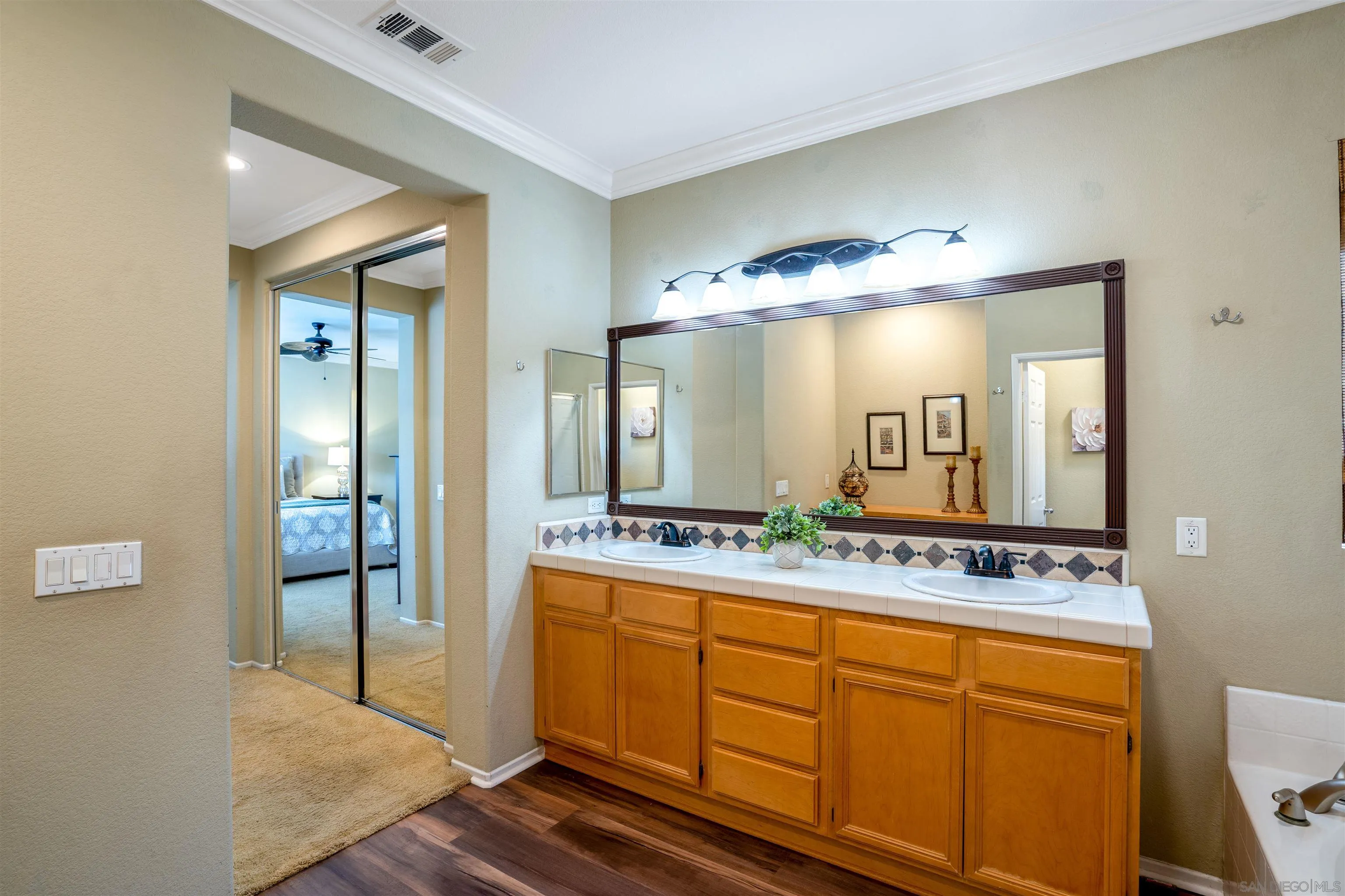 38837 Rockinghorse Road Murrieta, CA 92563 - Photo 26 of 41 a bathroom with a granite countertop sink and a mirror