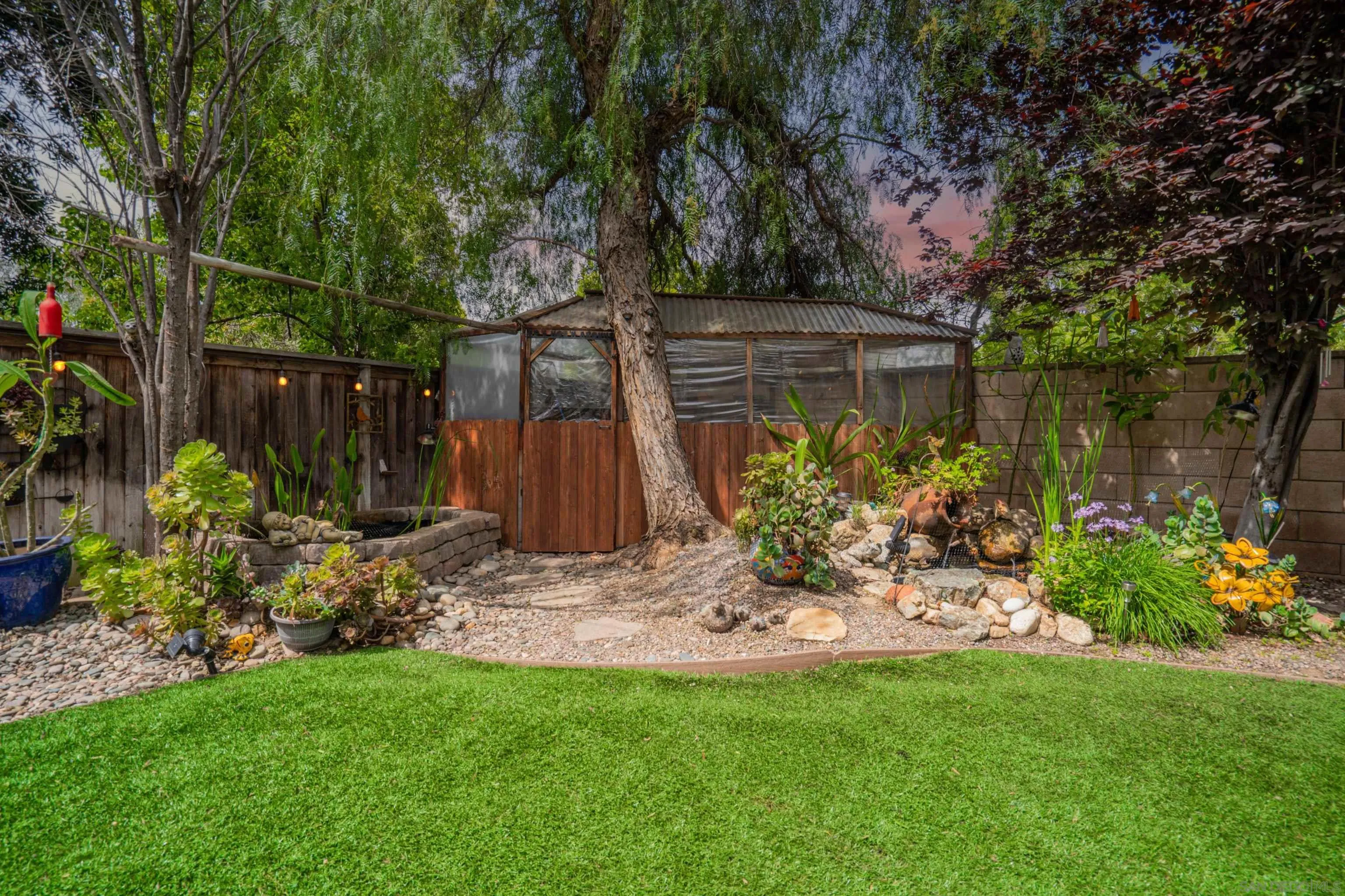 38837 Rockinghorse Road Murrieta, CA 92563 - Photo 36 of 41 a view of a backyard with plants and a large tree