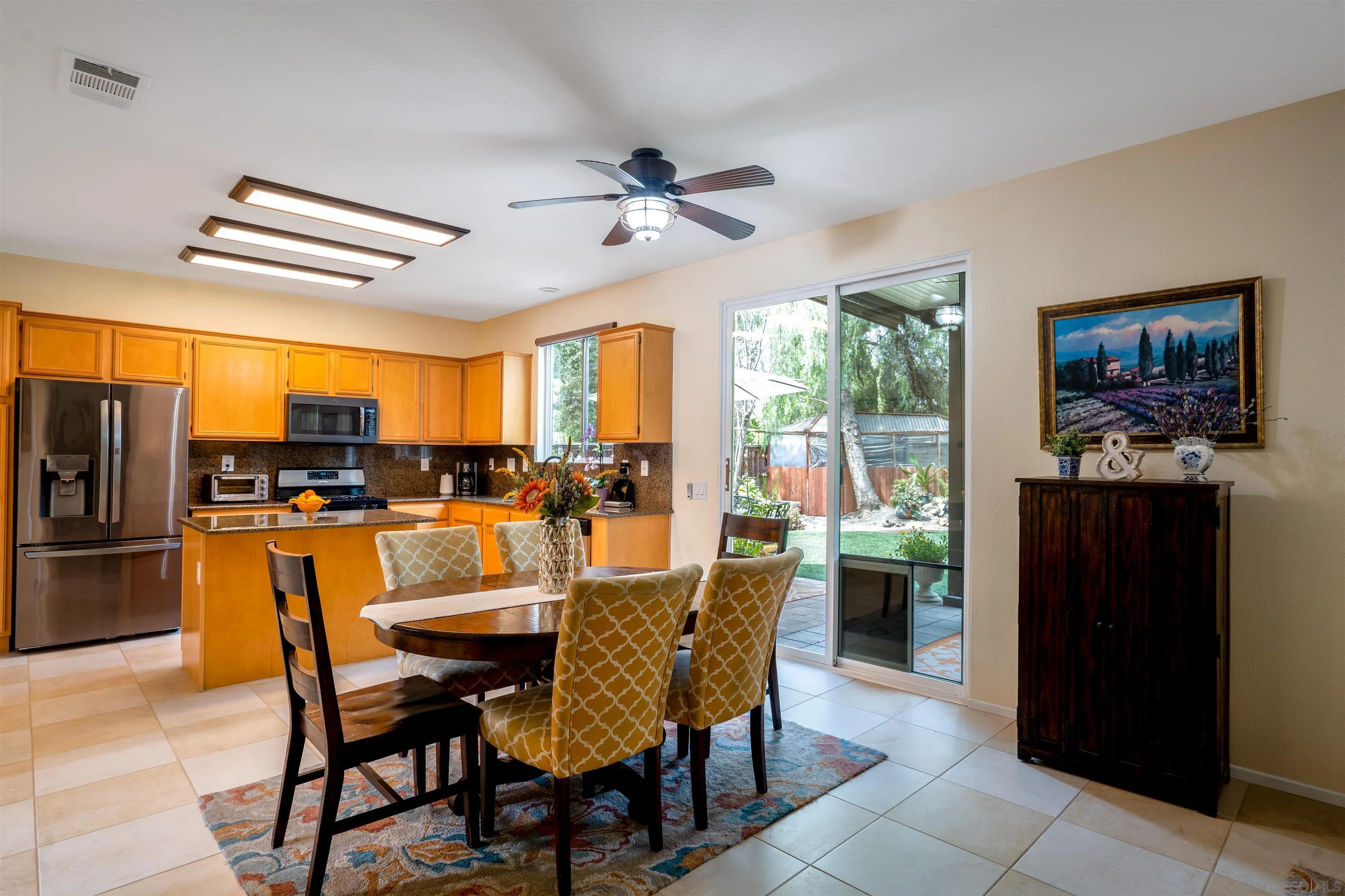 38837 Rockinghorse Road Murrieta, CA 92563 - Photo 10 of 41 a dining room with stainless steel appliances kitchen island granite countertop furniture and a livingroom