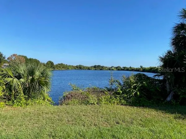 a view of a lake with houses in the back