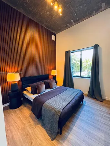 a bedroom with two beds and a large window