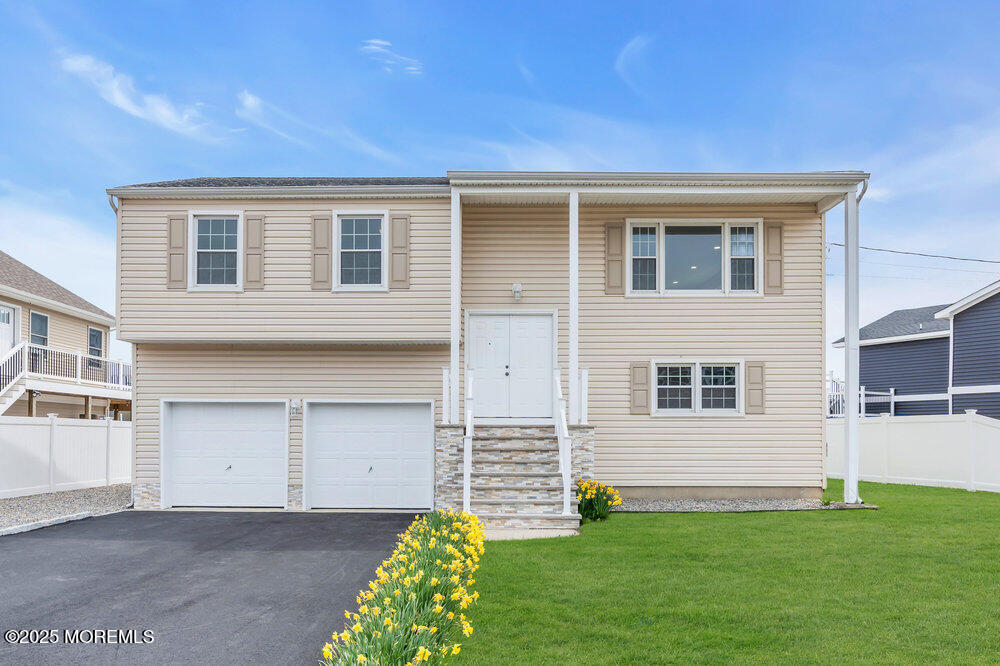 26 Mermaid Road Toms River, NJ 08753 - Photo 1 of 48 a front view of a house with a garden and yard