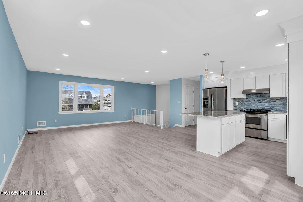 26 Mermaid Road Toms River, NJ 08753 - Photo 13 of 48 a view of kitchen with kitchen island stainless steel appliances refrigerator stove microwave and cabinets