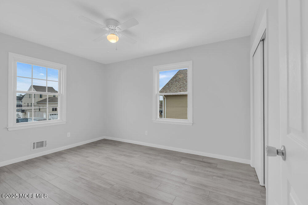 26 Mermaid Road Toms River, NJ 08753 - Photo 26 of 48 a view of an empty room with wooden floor and a window