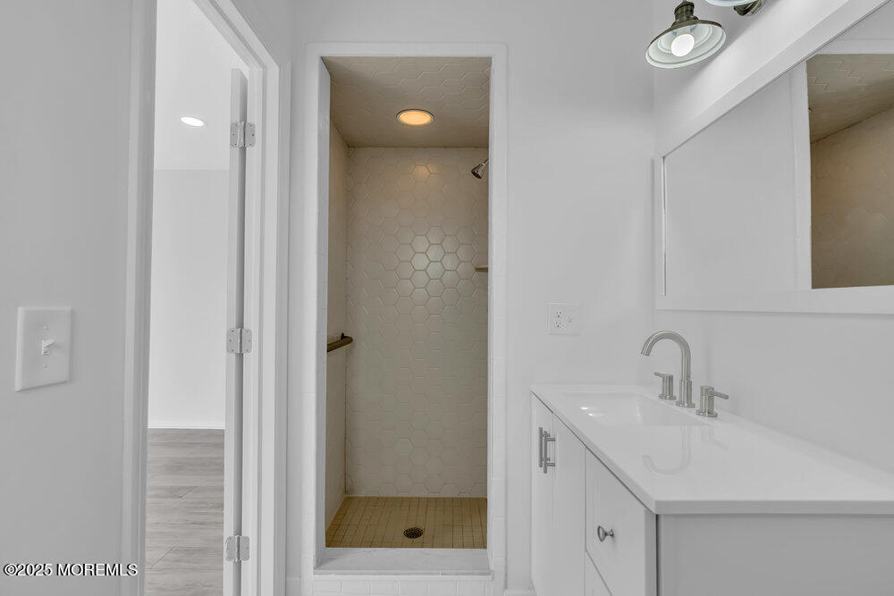 26 Mermaid Road Toms River, NJ 08753 - Photo 32 of 48 a bathroom with a sink mirror and shower