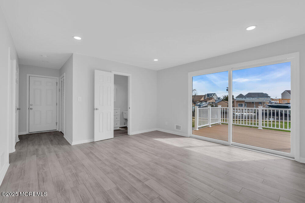26 Mermaid Road Toms River, NJ 08753 - Photo 35 of 48 an empty room with wooden floor and windows