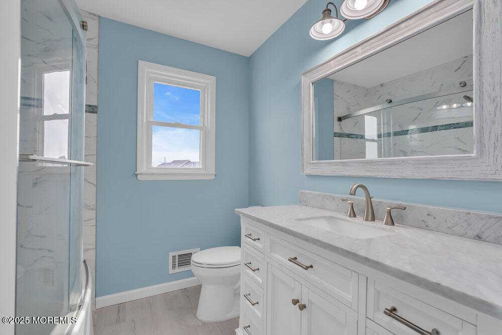 26 Mermaid Road Toms River, NJ 08753 - Photo 5 of 48 a bathroom with a toilet sink and mirror