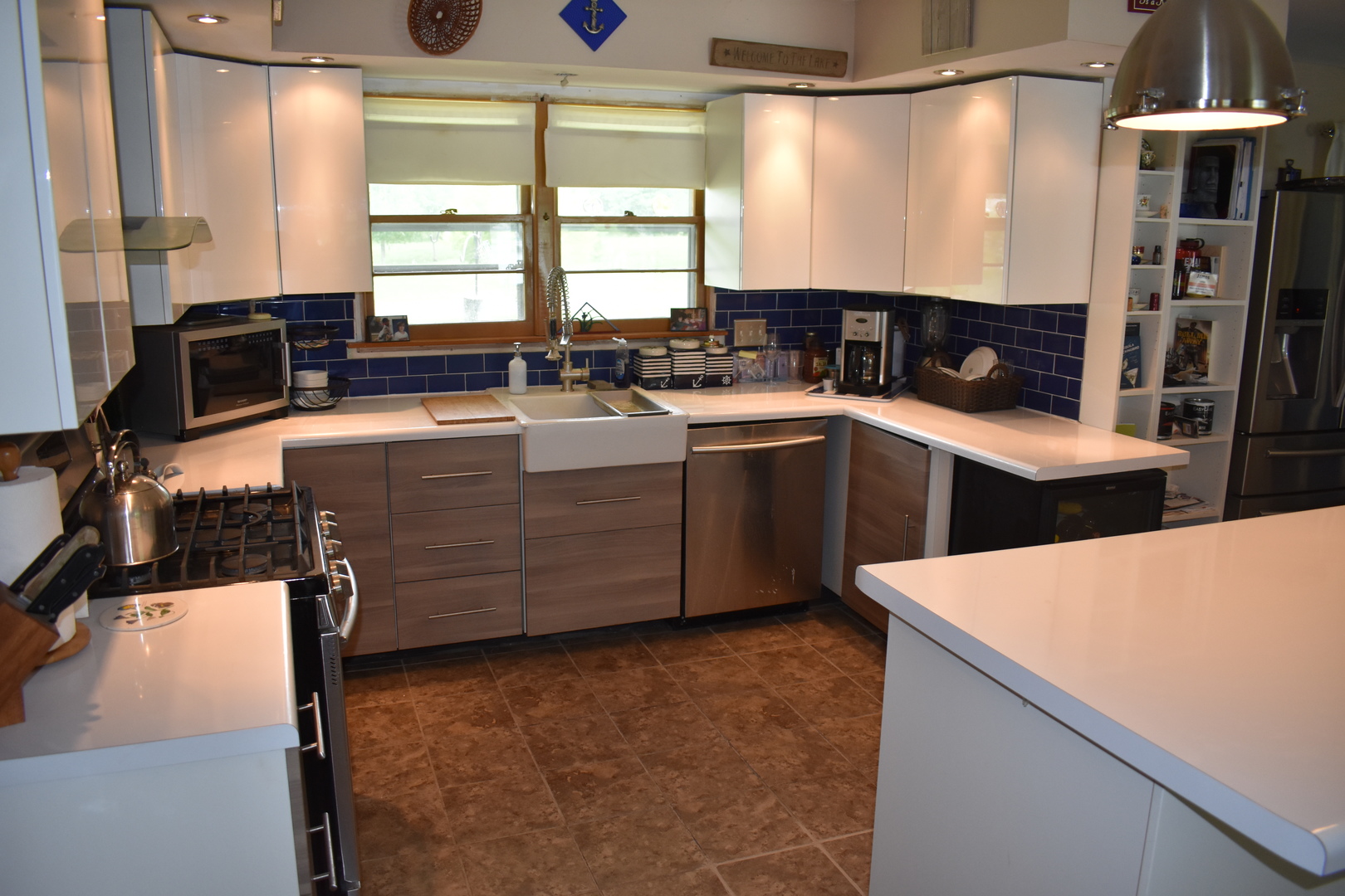 302 Weaver Court Loda, IL 60948 - Photo 9 of 25 a kitchen with stainless steel appliances kitchen island granite countertop a stove a sink and a microwave