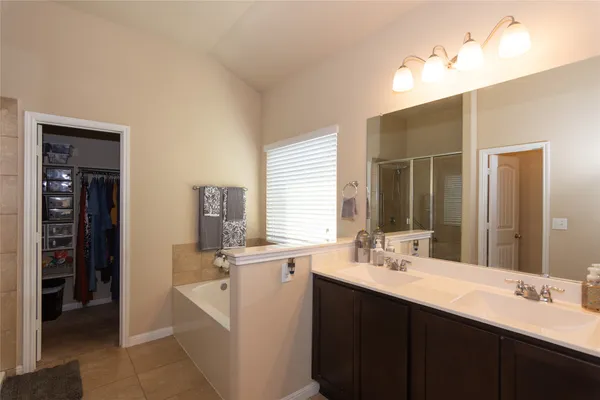 a bathroom with a sink double vanity and a mirror