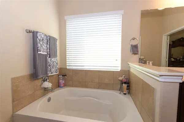 a white bath tub sitting next to a white sink