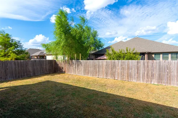 a view of a backyard with a fence