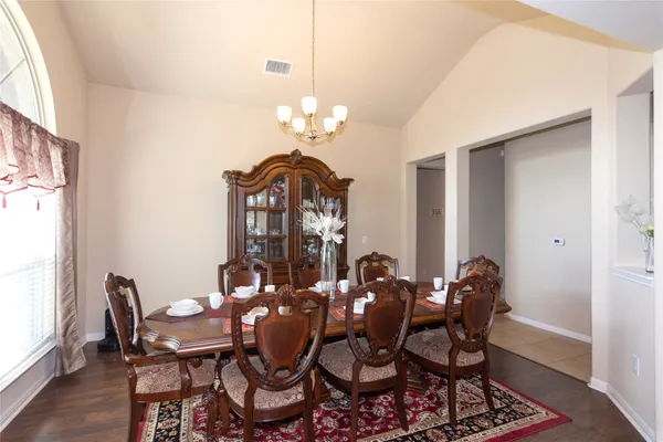 a view of a dining room with furniture and chandelier