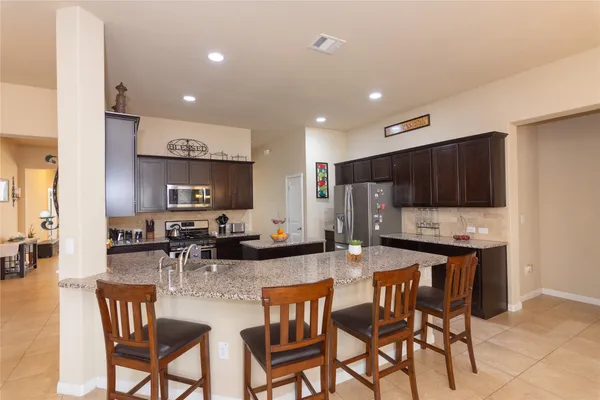 a kitchen with lots of counter space and chairs
