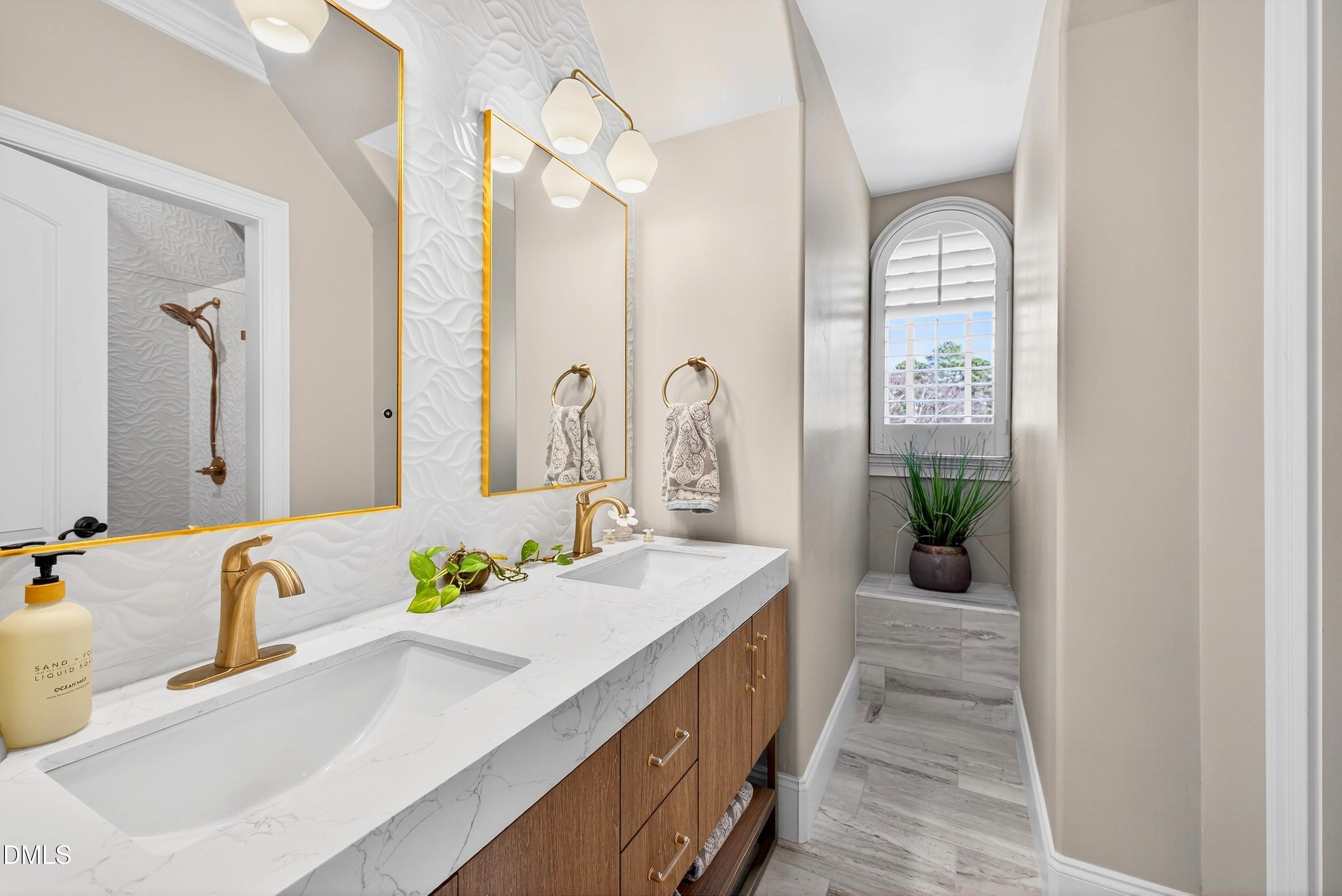 6701 Foxfire Place Raleigh, NC 27615 - Photo 43 of 67 a bathroom with a granite countertop sink and a mirror