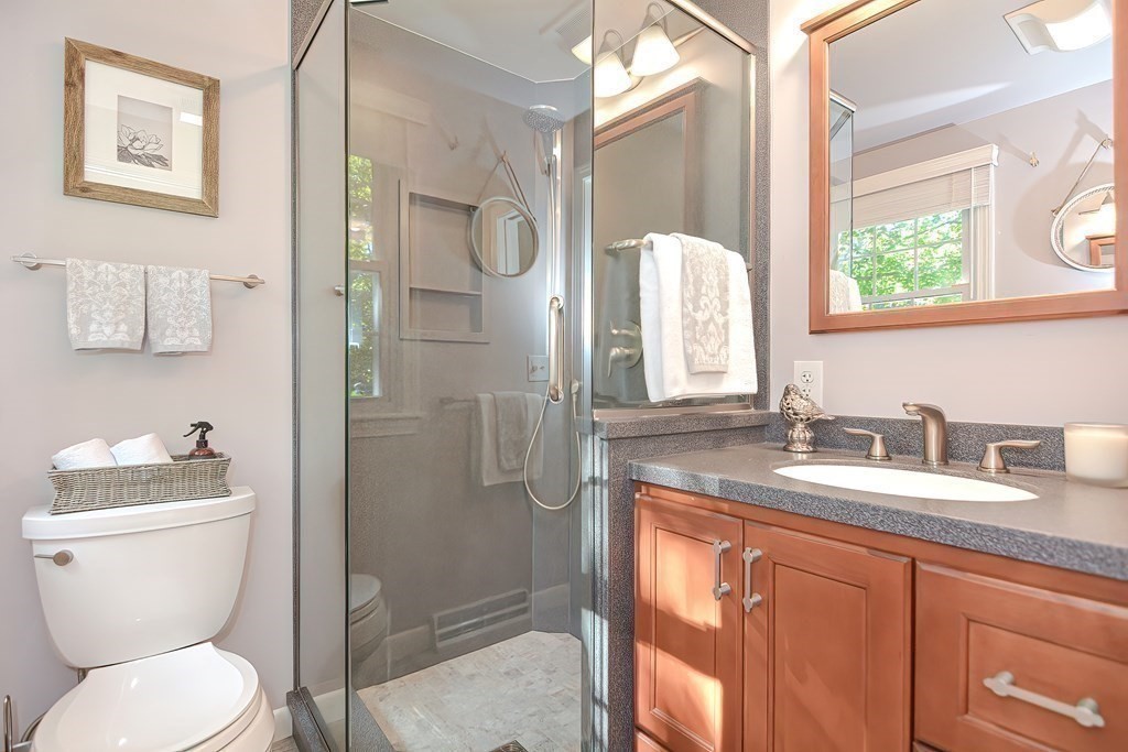 2 Meadowbrook Road Acton, MA 01720 - Photo 21 of 36 a bathroom with a granite countertop toilet sink and mirror