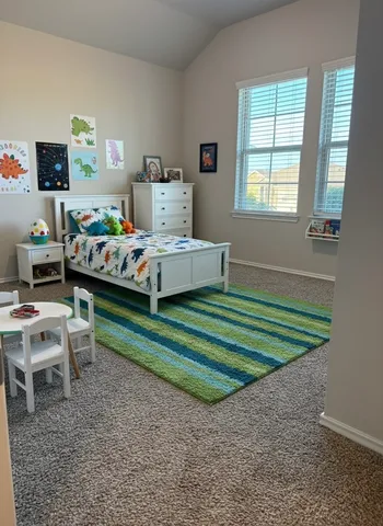 a bedroom with a bed and a window