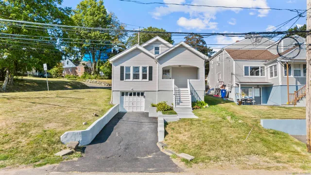 a view of a house with pool and chairs
