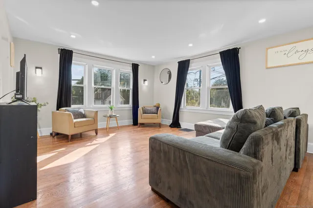 a living room with furniture and large windows