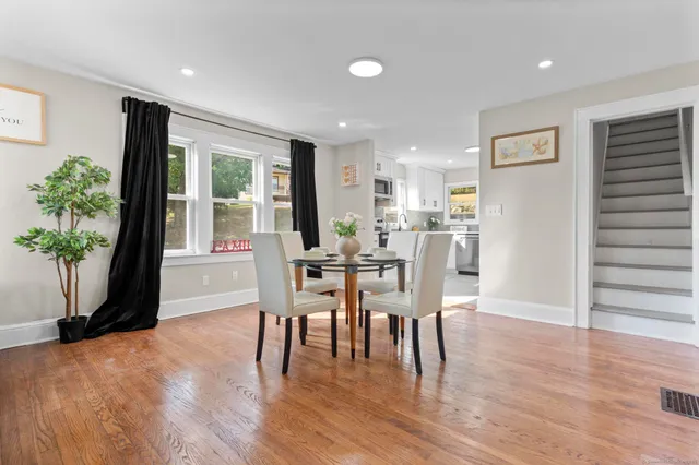 a view of a dining room with furniture and wooden floor
