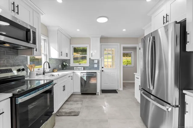 a kitchen with a sink stainless steel appliances and cabinets