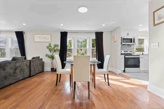 a view of a dining room with furniture window and wooden floor