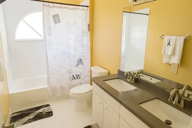 a bedroom with double bed and a chandelier