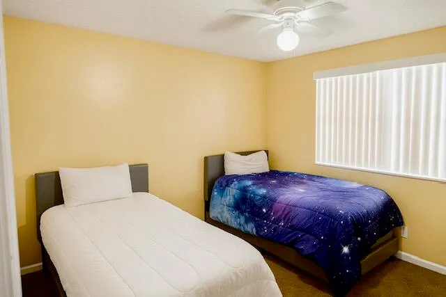 a bedroom with a bed and window