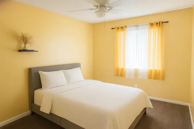 a bedroom with a bed and window