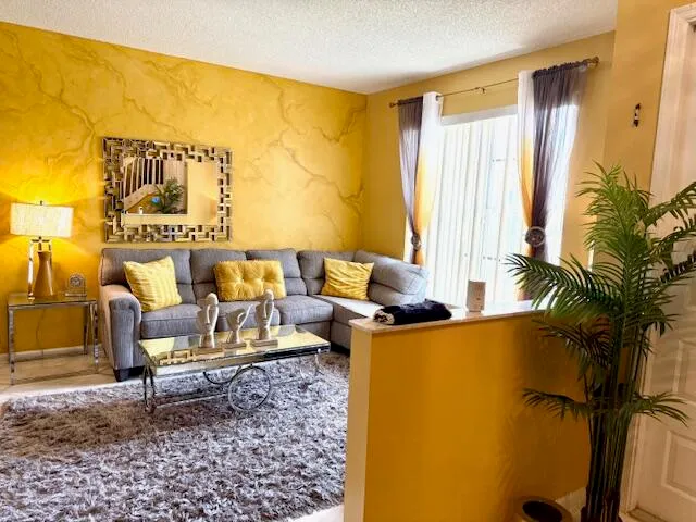 a living room with furniture and a large window