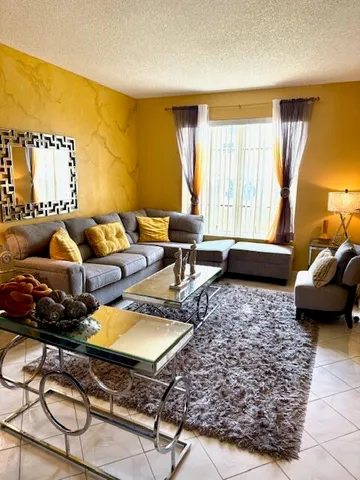 a kitchen with stainless steel appliances granite countertop a sink refrigerator and microwave