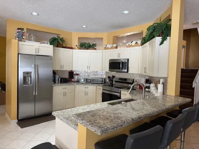 a kitchen with a sink stove and microwave