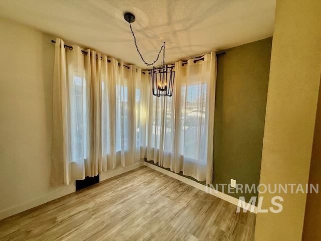 1139 Webster Street Clarkston, WA 99403 - Photo 21 of 34 Unfurnished dining area featuring a chandelier and light wood finished floors