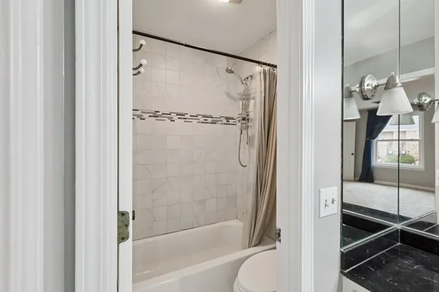 a bathroom with a bathtub and a shower