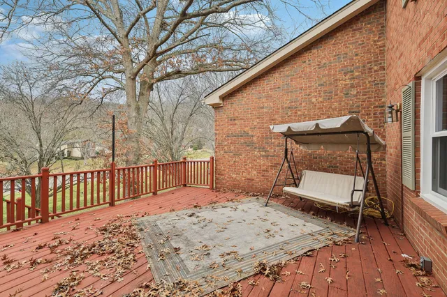 a view of backyard with a deck and wooden floor