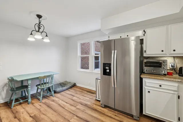 a kitchen with stainless steel appliances a refrigerator and microwave