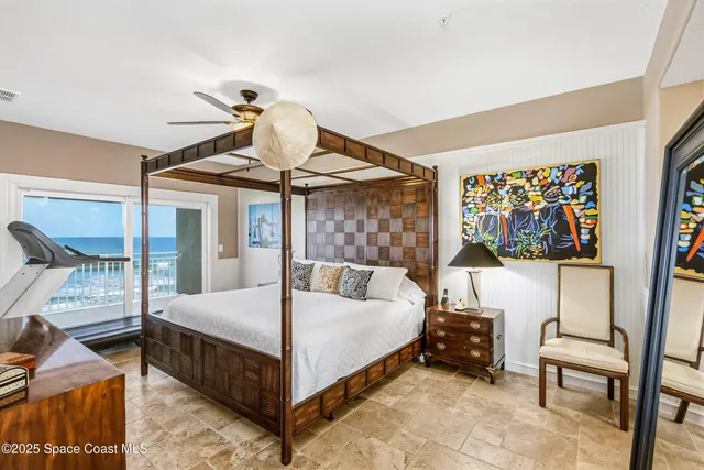 a bedroom with a bed and a painting on the wall