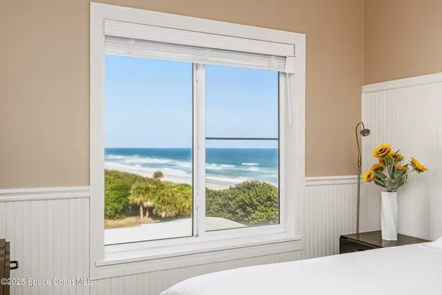 a living room with furniture and a painting on the wall